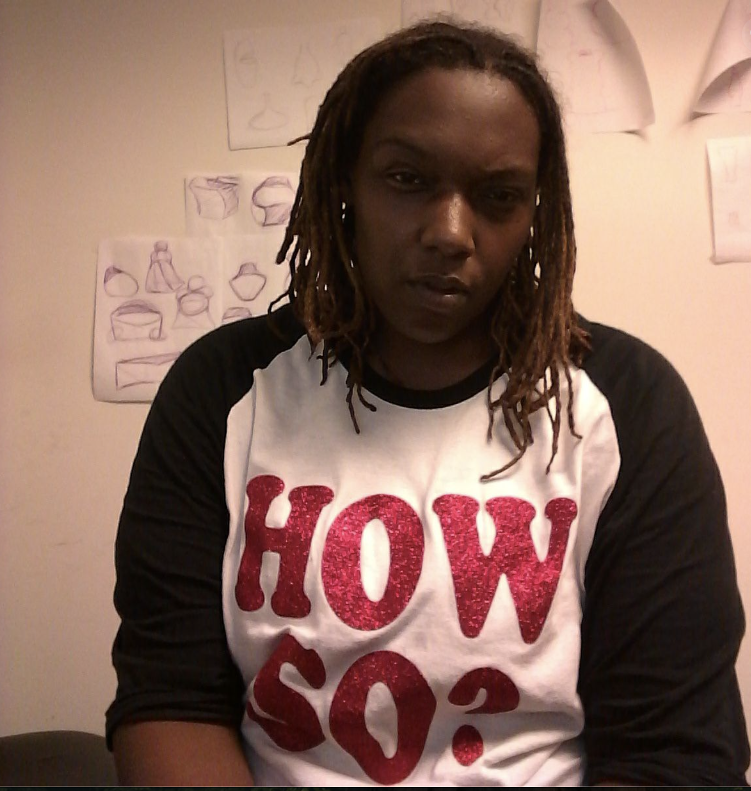 Kiana Kai wearing a HOW SO? shirt